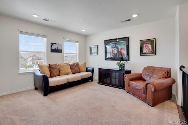 living area featuring light carpet, baseboards, and recessed lighting