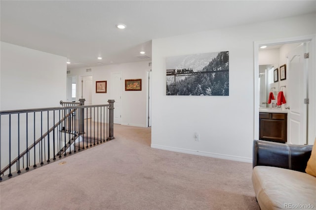 corridor featuring an upstairs landing, recessed lighting, carpet floors, and baseboards