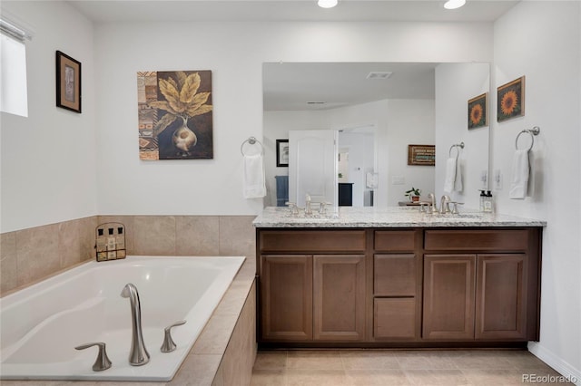 full bath featuring double vanity, a bath, recessed lighting, and tile patterned flooring