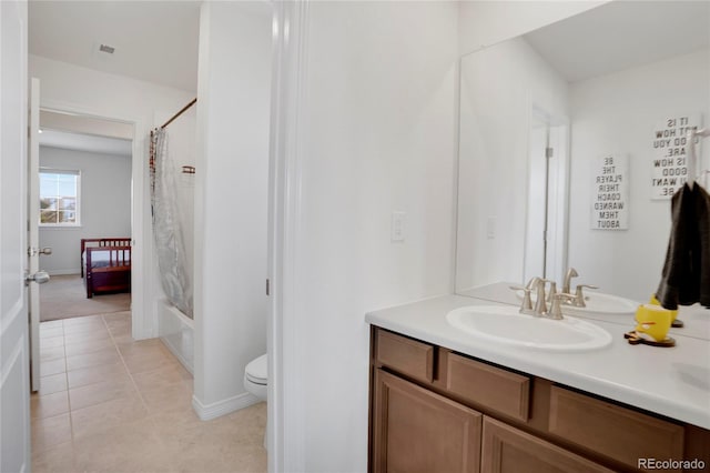 bathroom featuring toilet, vanity, tile patterned flooring, shower / tub combo with curtain, and baseboards