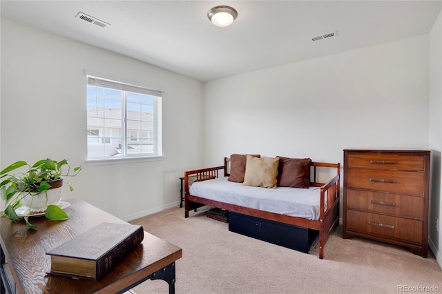 bedroom with light carpet and baseboards
