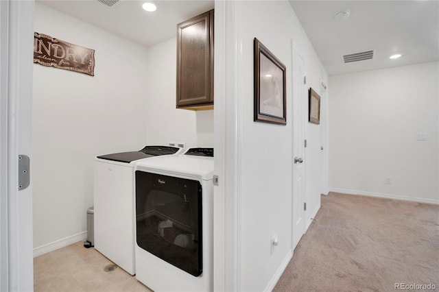 laundry area featuring cabinet space, washer and dryer, recessed lighting, light colored carpet, and baseboards