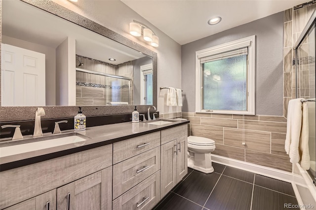 6338 S Oneida Ct, Centennial, CO 80111 - bathroom featuring tile walls, double vanity, a stall shower, toilet, and tile patterned floors