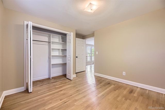 6338 S Oneida Ct, Centennial, CO 80111 - unfurnished bedroom with light wood finished floors, baseboards, and a closet