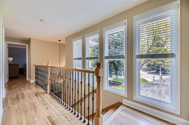 6338 S Oneida Ct, Centennial, CO 80111 - corridor with wood finished floors, baseboards, and an upstairs landing