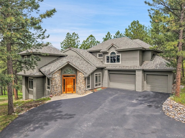 29433 Firethorne Ct, Evergreen, CO 80439 - view of front of property with asphalt driveway, stone siding, a shingled roof, and a garage