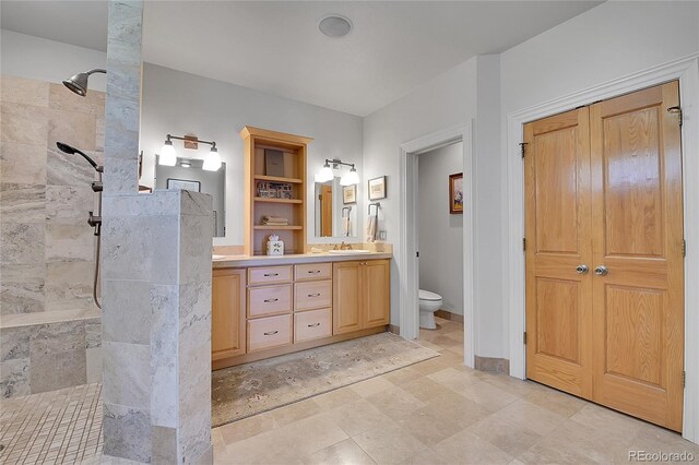29433 Firethorne Ct, Evergreen, CO 80439 - bathroom with double vanity, a walk in shower, and toilet