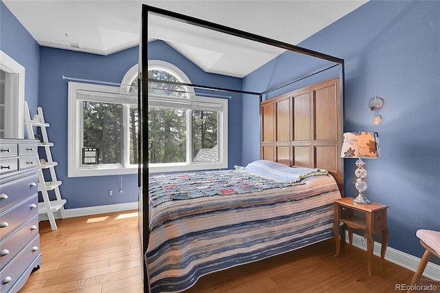 29433 Firethorne Ct, Evergreen, CO 80439 - bedroom with light wood finished floors, baseboards, and vaulted ceiling