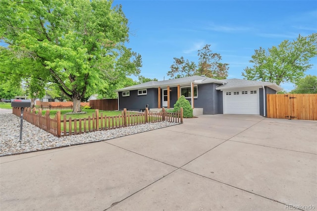 2598 Teller St, Lakewood, CO 80214 - ranch-style house with a garage, driveway, and a fenced front yard