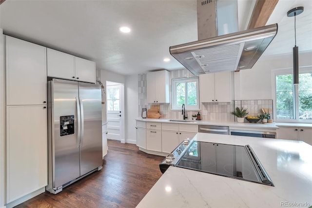 2598 Teller St, Lakewood, CO 80214 - kitchen with stainless steel appliances, island exhaust hood, a sink, backsplash, and recessed lighting