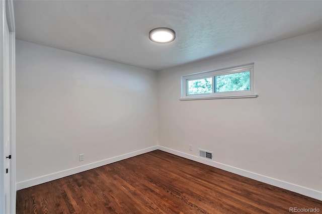 2598 Teller St, Lakewood, CO 80214 - spare room with baseboards and dark wood finished floors