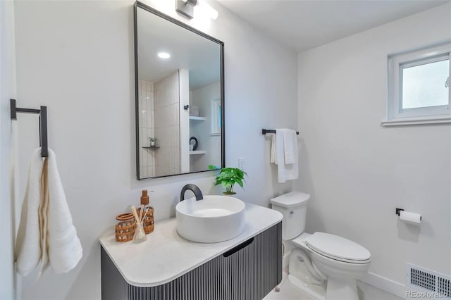 2598 Teller St, Lakewood, CO 80214 - bathroom featuring toilet, vanity, and baseboards