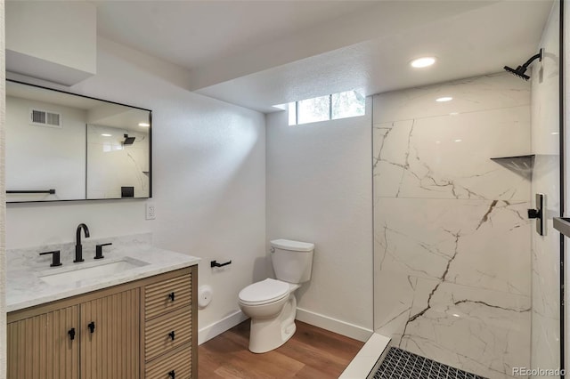 2598 Teller St, Lakewood, CO 80214 - bathroom with toilet, vanity, a marble finish shower, wood finished floors, and recessed lighting
