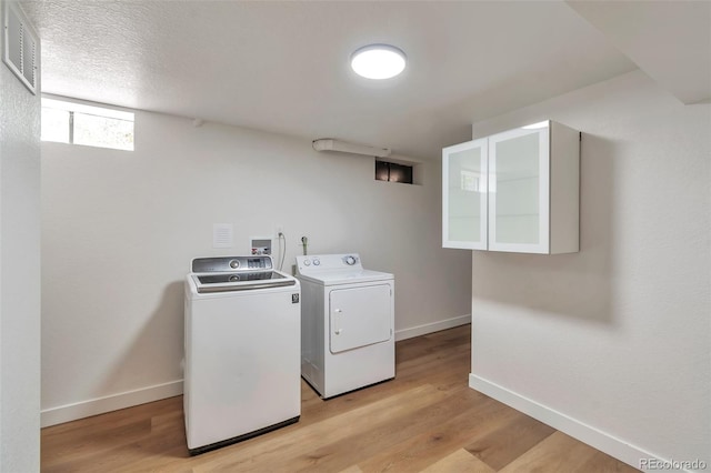 2598 Teller St, Lakewood, CO 80214 - washroom featuring independent washer and dryer, baseboards, and light wood-type flooring
