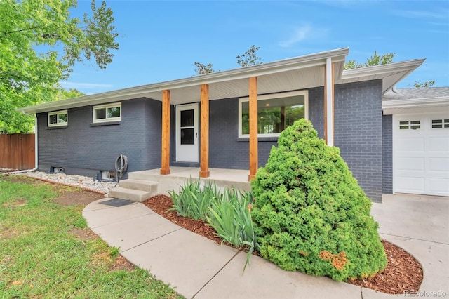 2598 Teller St, Lakewood, CO 80214 - single story home featuring covered porch, brick siding, and an attached garage