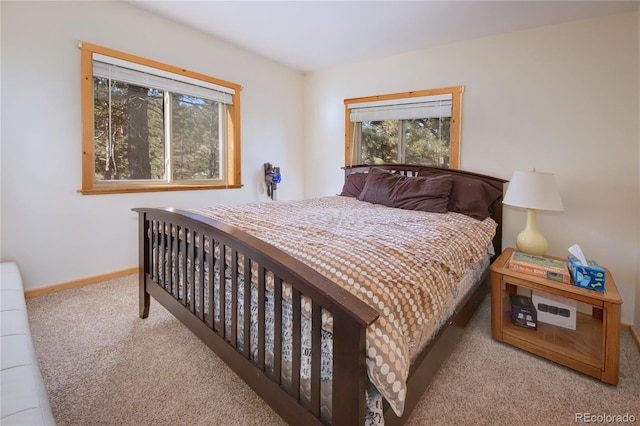 carpeted bedroom featuring multiple windows