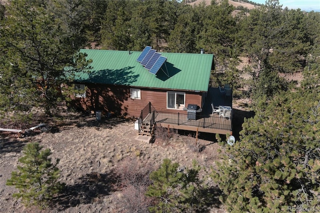 exterior space featuring solar panels and a deck