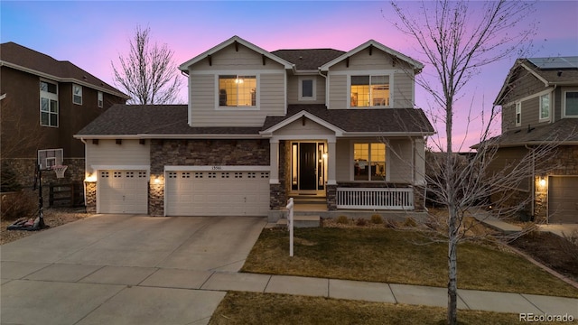 view of front of home with a shingled roof, concrete driveway, covered porch, an attached garage, and stone siding