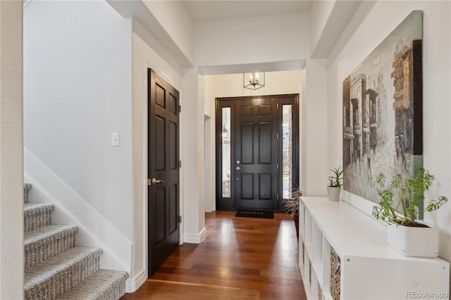 foyer with dark wood-style floors and stairway