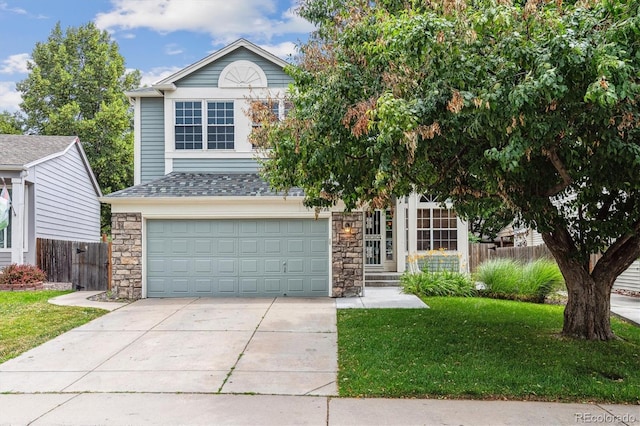 2780 S Cathay Ct, Aurora, CO 80013 - view of front of home featuring an attached garage, concrete driveway, and stone siding