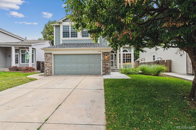 2780 S Cathay Ct, Aurora, CO 80013 - view of front of house with driveway, an attached garage, and stone siding