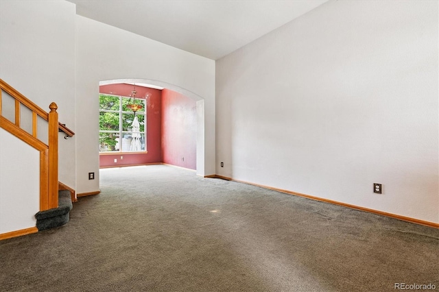 2780 S Cathay Ct, Aurora, CO 80013 - unfurnished living room featuring arched walkways, carpet floors, and stairway