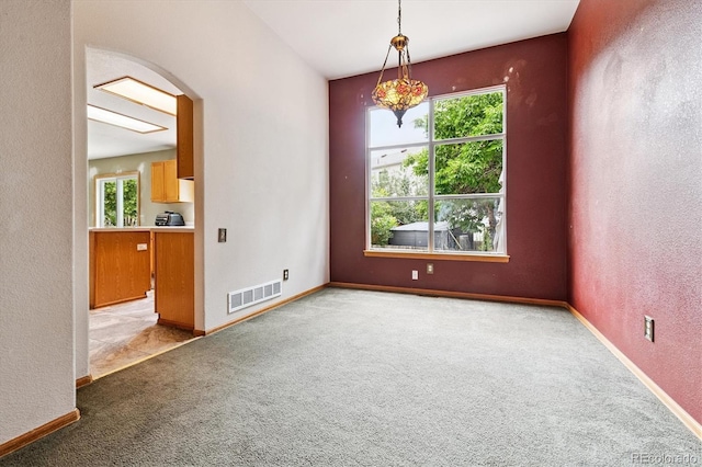 2780 S Cathay Ct, Aurora, CO 80013 - carpeted spare room with plenty of natural light, arched walkways, and a textured wall