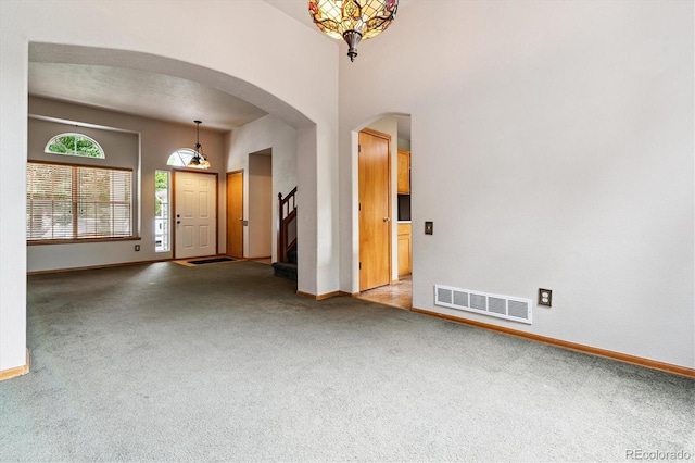 2780 S Cathay Ct, Aurora, CO 80013 - empty room with carpet, arched walkways, and stairway