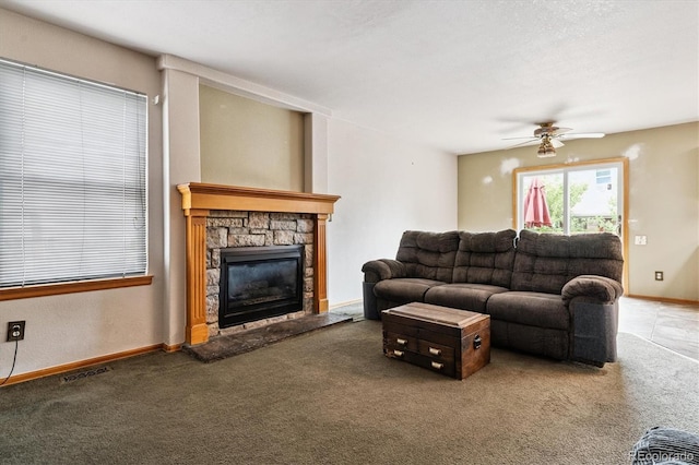 2780 S Cathay Ct, Aurora, CO 80013 - living area with carpet floors, a stone fireplace, and ceiling fan