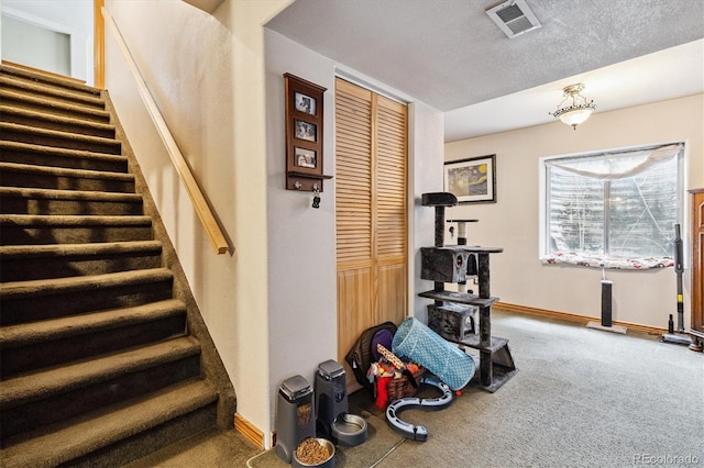 2780 S Cathay Ct, Aurora, CO 80013 - staircase featuring carpet flooring and a textured ceiling