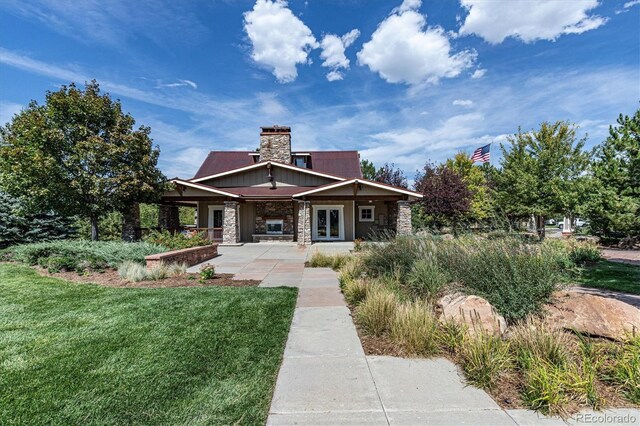 24714 E Quarto Pl, Aurora, CO 80016 - rear view of house with stone siding, a yard, a chimney, and french doors