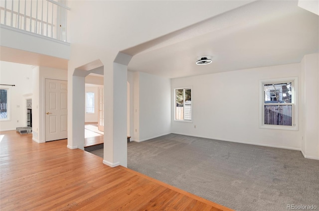 unfurnished living room with light colored carpet