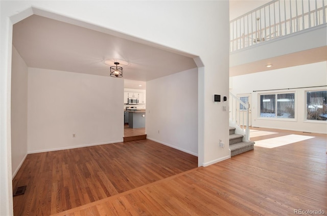 unfurnished living room with hardwood / wood-style floors