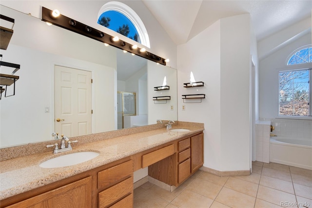 bathroom with lofted ceiling, vanity, tile patterned flooring, and plus walk in shower