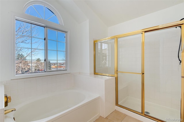 bathroom with tile patterned flooring, vaulted ceiling, independent shower and bath, and plenty of natural light