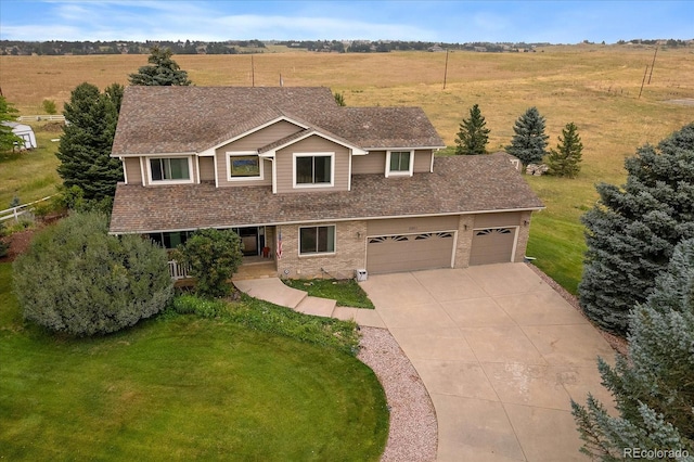 view of front of home featuring a garage and a front yard