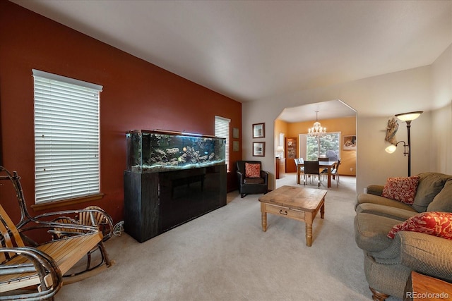 living room featuring light carpet and an inviting chandelier