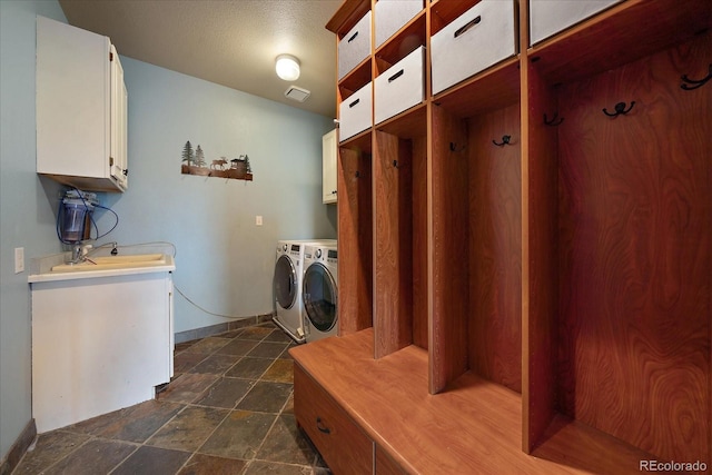 clothes washing area featuring sink, independent washer and dryer, and cabinets