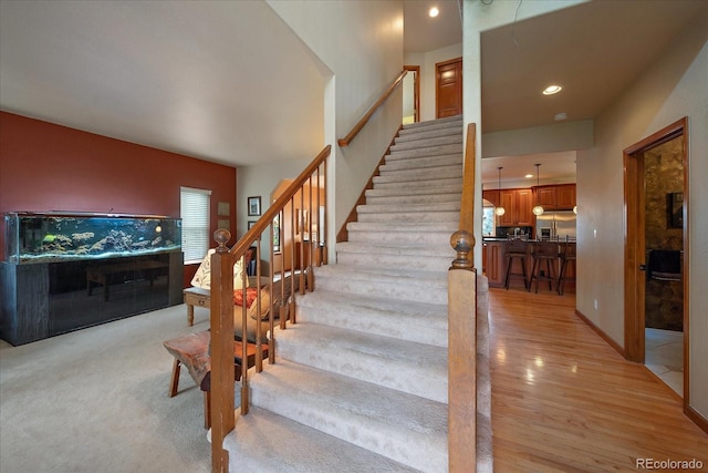 staircase with hardwood / wood-style floors