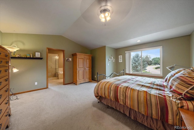 bedroom with ensuite bath, light colored carpet, ceiling fan, and lofted ceiling