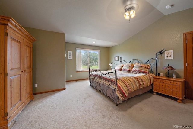 bedroom featuring ceiling fan, lofted ceiling, and light colored carpet