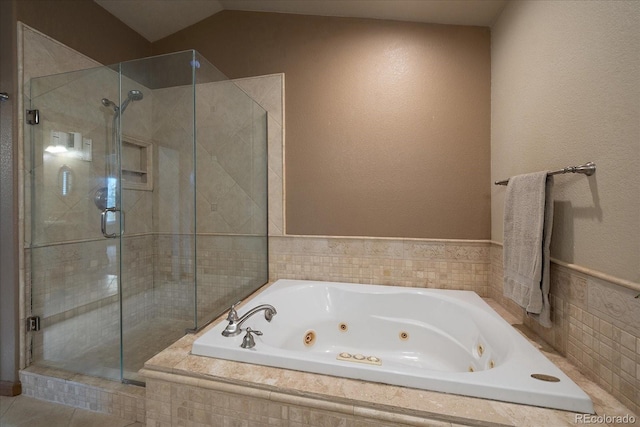 bathroom with separate shower and tub and lofted ceiling