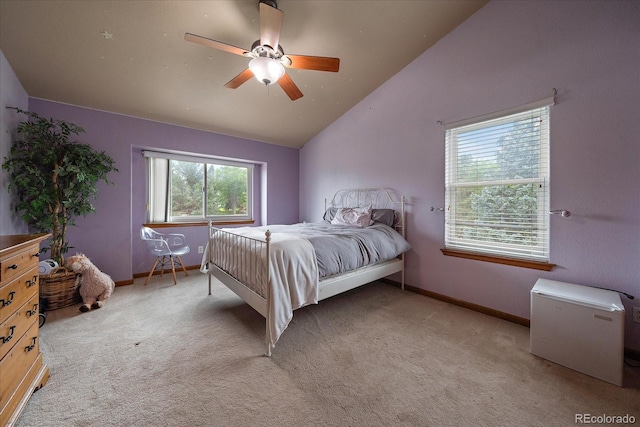 carpeted bedroom with ceiling fan and vaulted ceiling