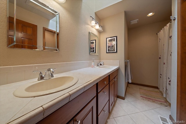 bathroom with tile patterned floors and vanity