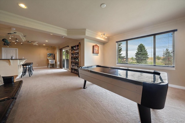 game room featuring a wealth of natural light, light colored carpet, and crown molding