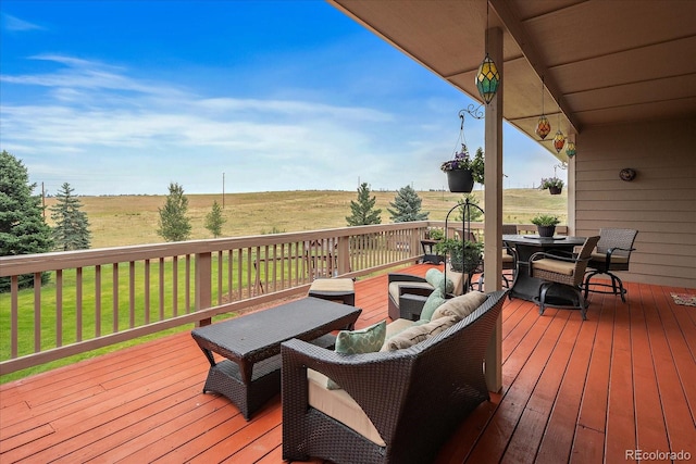 wooden deck featuring a rural view and a yard