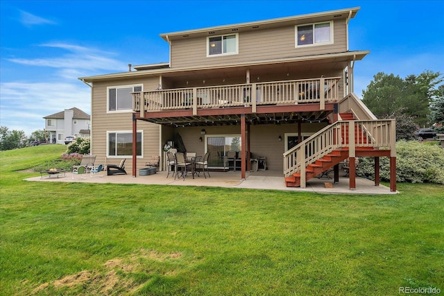 rear view of property with a patio, a lawn, and a wooden deck