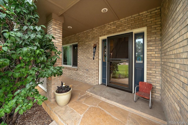 5861 E Valley Hi Dr, Parker, CO 80138 - doorway to property featuring brick siding and covered porch