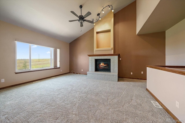 5861 E Valley Hi Dr, Parker, CO 80138 - unfurnished living room featuring a ceiling fan, lofted ceiling, a fireplace, carpet, and track lighting