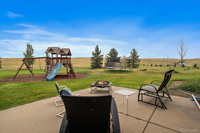 5861 E Valley Hi Dr, Parker, CO 80138 - view of patio featuring a trampoline, a playground, and a fire pit